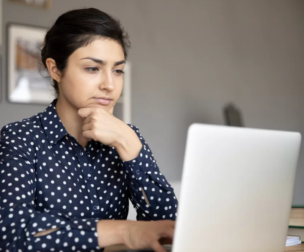 Photograph of woman and laptop.